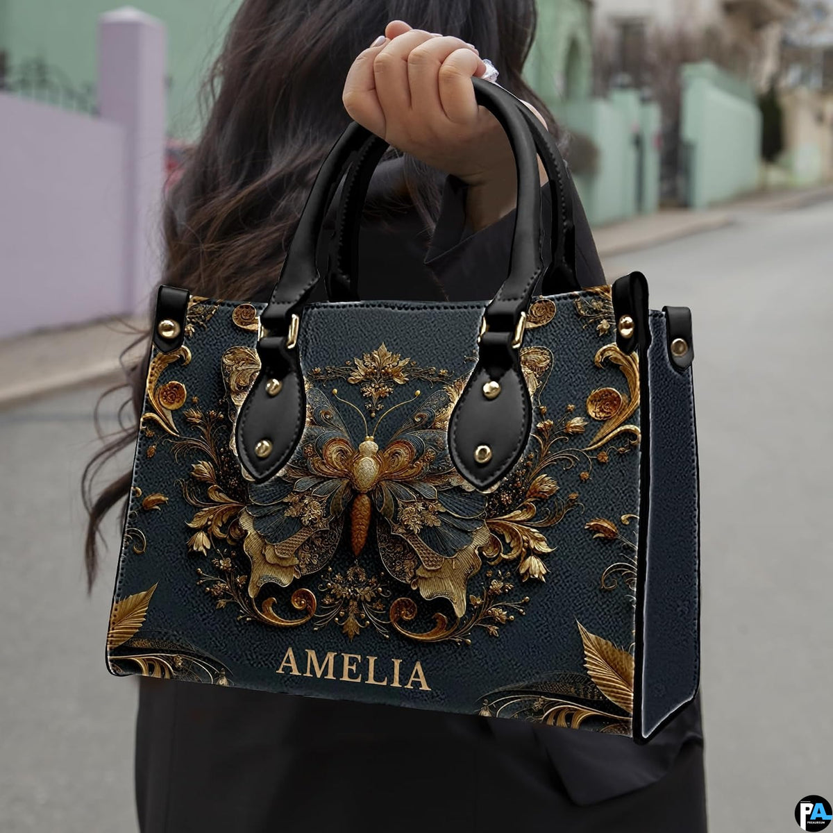 Street lifestyle view of antique gold butterfly handbag held by hand on sidewalk