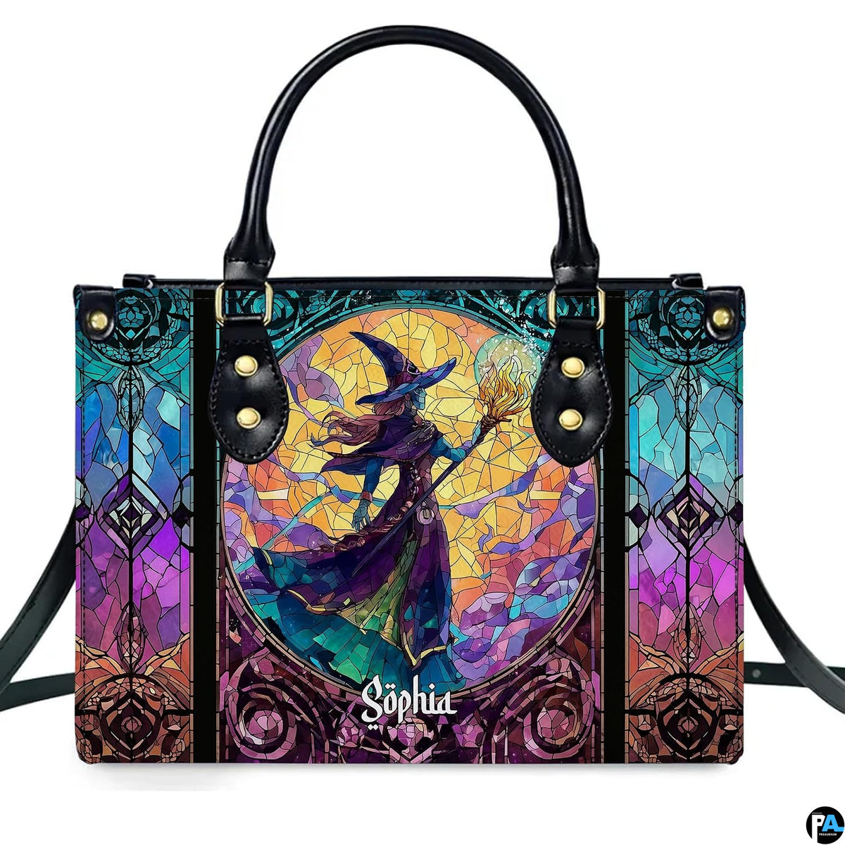 Stained glass witch handbag displayed on white table beside floral bouquet.