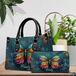 Butterfly handbag and matching wallet displayed together on tabletop setting