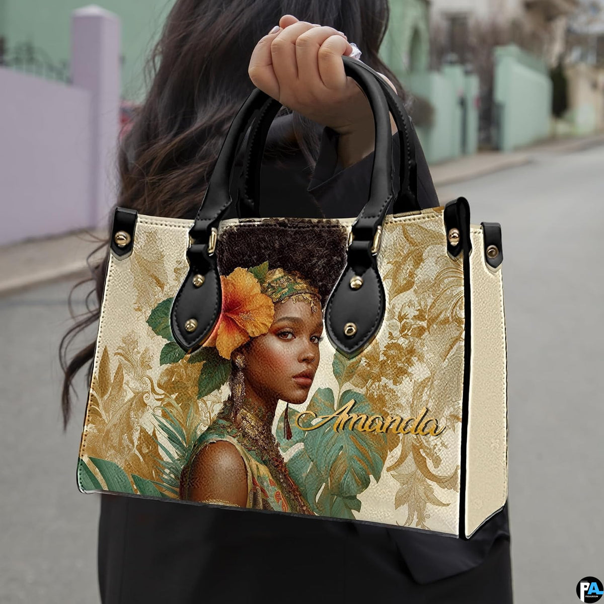 Urban outdoor photo showing the tropical woman portrait artwork held along a city street.