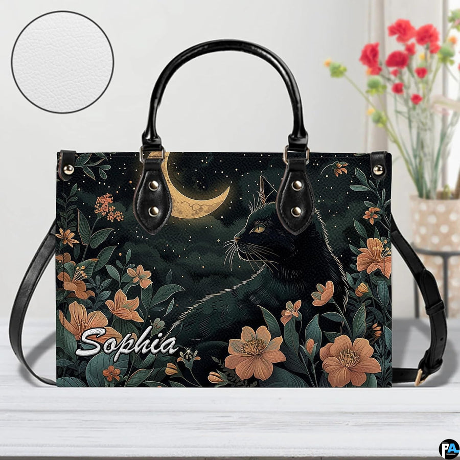Studio display of nocturnal black cat and crescent moon floral artwork.