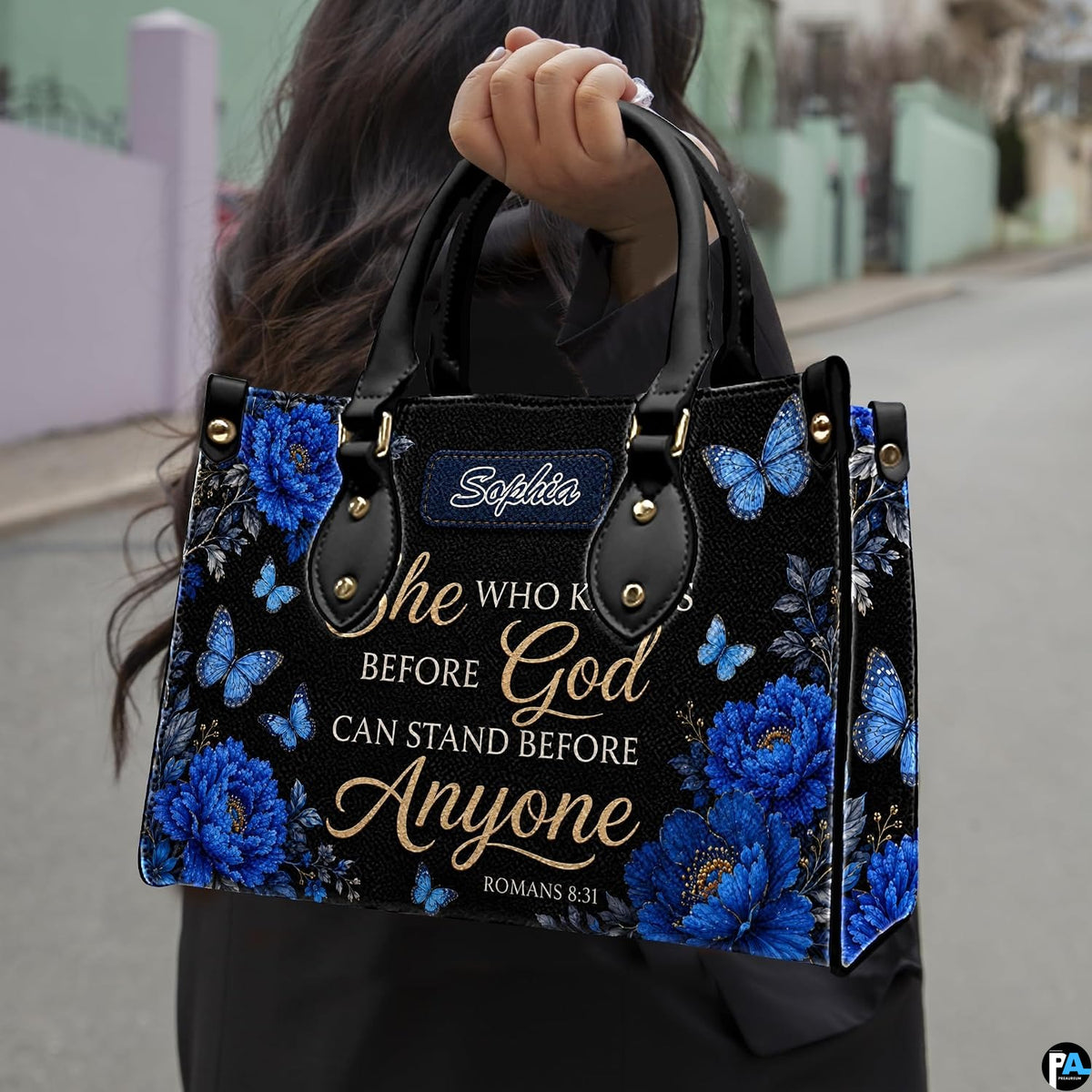 Detailed angle view of royal blue floral blooms and fluttering butterflies against dark background on handbag.