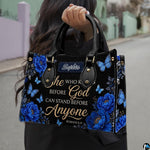 Detailed angle view of royal blue floral blooms and fluttering butterflies against dark background on handbag.