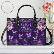 Arrangement of purple handbag and wallet presenting the unified diamond butterfly theme.