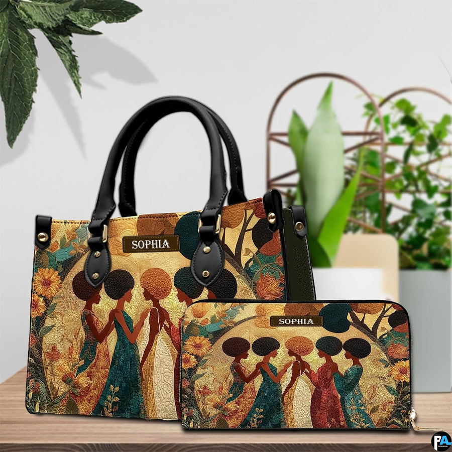 Artistic presentation of the sunflower sisterhood design placed on a wooden surface beside lush green leaves.