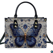 Straight-on studio portrait of Delftware floral butterfly handbag against white background