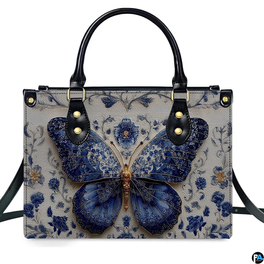 Straight-on studio portrait of Delftware floral butterfly handbag against white background