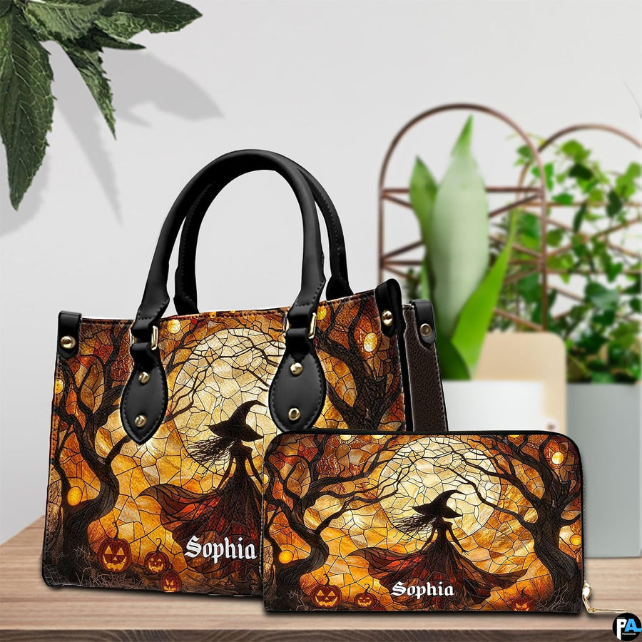 Stained glass Halloween witch handbag displayed on wooden tabletop in front of sunlit windows.