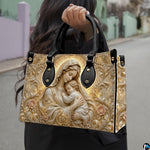 Matching golden relief Madonna handbag and wallet set in botanical lifestyle display