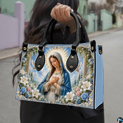 Side profile view of structured Madonna handbag showing silhouette and black carry handles