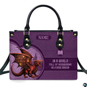 Fantasy book dragon violet handbag displayed alone on white studio background.