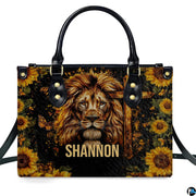 Side profile view of structured lion sunflower cross handbag.