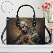 Immaculate Heart of Mary handbag displayed on a white wooden table near flower bouquet