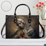 Immaculate Heart of Mary handbag displayed on a white wooden table near flower bouquet