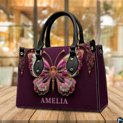 Back view of jeweled butterfly handbag displaying textured deep plum exterior surface