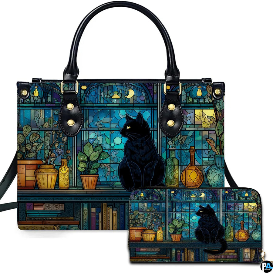 Studio presentation of cat on crescent moon stained glass art beside matching companion accessory.