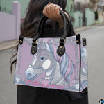 Model outdoors carrying pastel purple crowned unicorn handbag