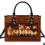 Front view displaying playful corgi pups arranged in a row across a rich brown accessory.
