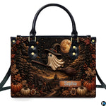Front view of structured satchel displaying ghost witch broomstick flight and pumpkin harvest illustration.