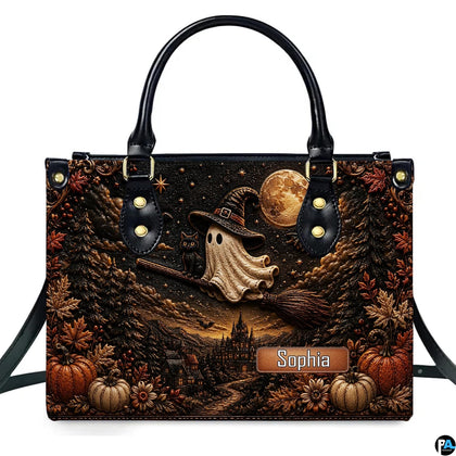 Front view of structured satchel displaying ghost witch broomstick flight and pumpkin harvest illustration.