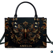 Straight-on studio portrait of antique gold butterfly handbag against solid white background
