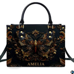 Straight-on studio portrait of antique gold butterfly handbag against solid white background
