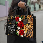 Christian leopard handbag carried outdoors by top handle on residential street.