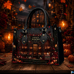 Tabletop view of gothic bookstore artwork surrounded by pumpkin lanterns and fallen autumn foliage.