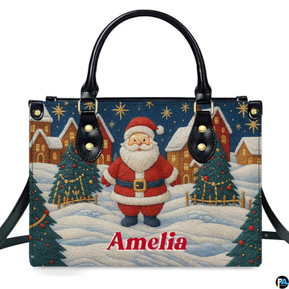 Front view of top-handle handbag featuring embroidered style Santa in a snowy Christmas village.