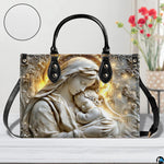 Bas-relief Madonna handbag displayed on white wooden table with texture swatch and background floral vase.