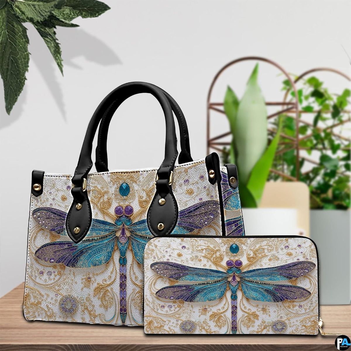 Coordinated arrangement of handbag and wallet displaying the matching dragonfly design.