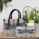 Coordinated arrangement of handbag and wallet displaying the matching dragonfly design.