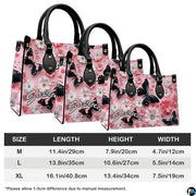 Side angle view of black butterfly pink daisy handbag and wallet