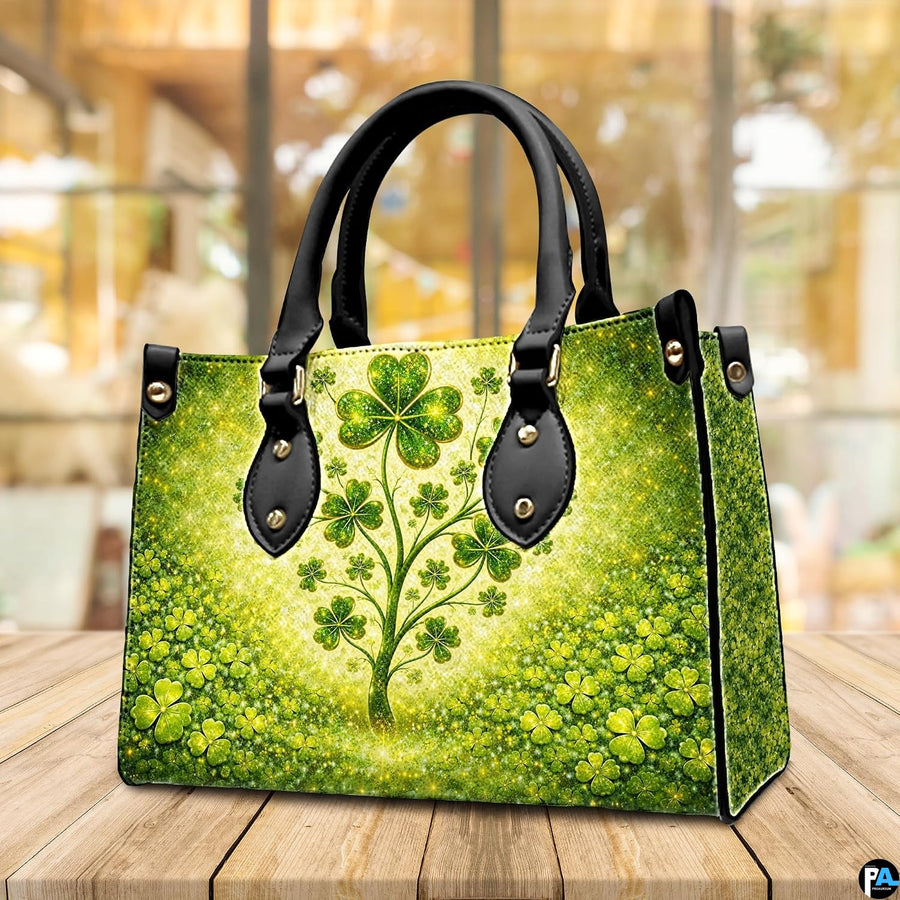 Angled clover tree handbag with dense green ground cover and gold sparkles