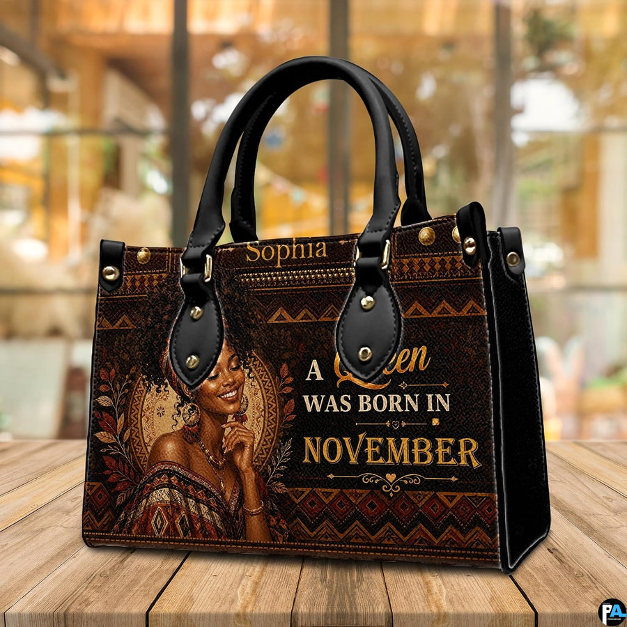 Angled African portrait handbag with gold lettering and geometric art
