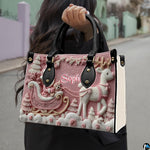 Model carrying the pink Santa and reindeer handbag outdoors by the top handles.