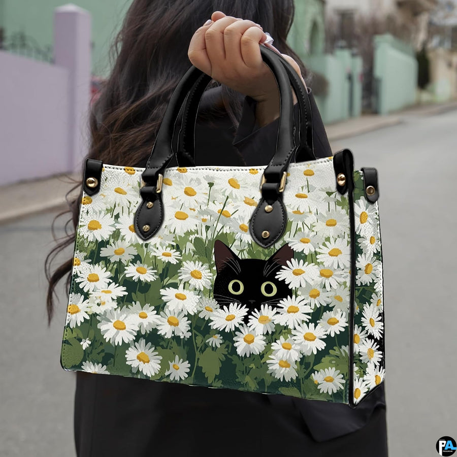 Street lifestyle setting of black cat in flower field painting held during a sunny stroll.