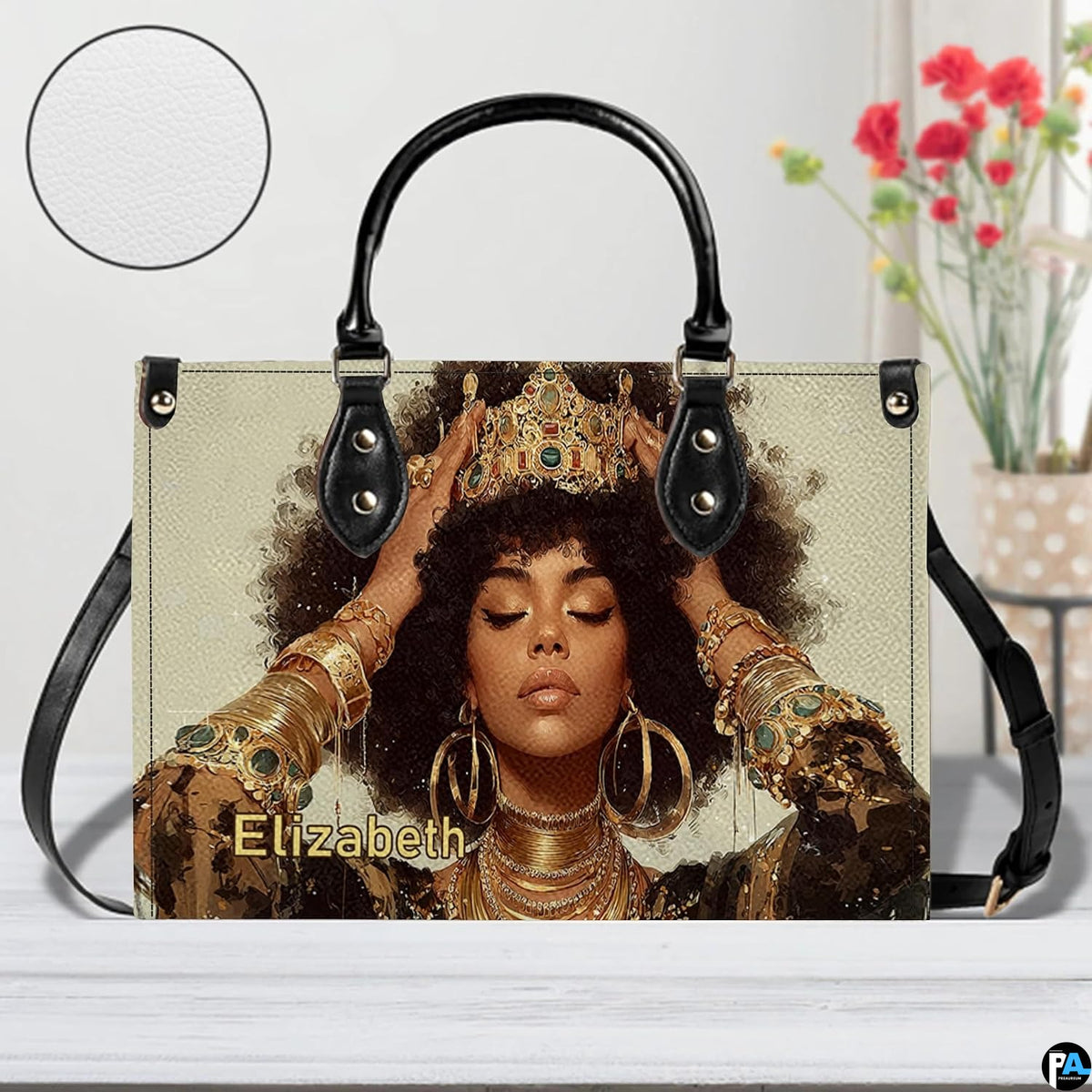 Front view of jeweled crown afro portrait handbag with gold hoops and bangles