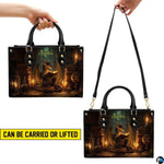 Bottom view of alchemist dragon handbag showing protective gold base hardware