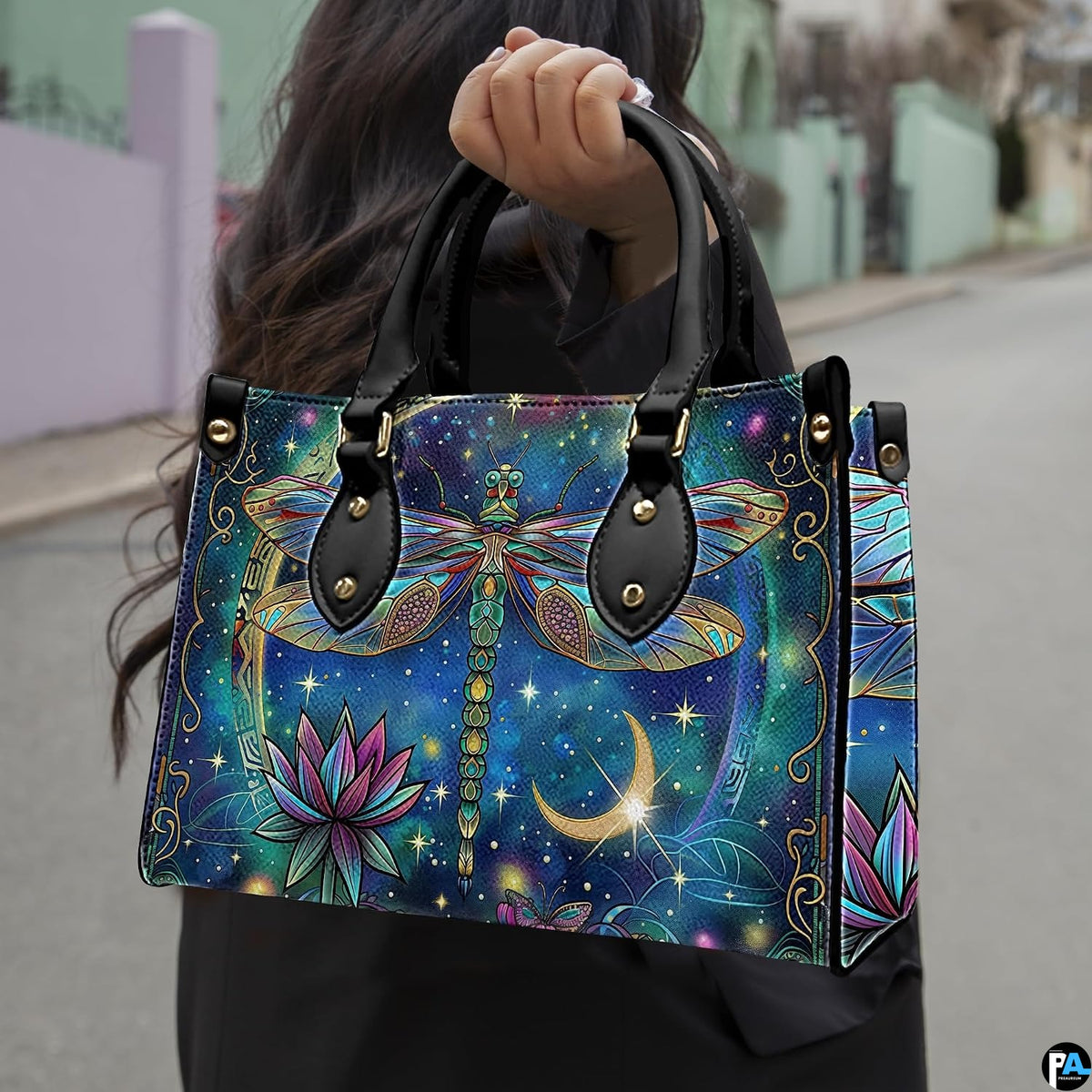 Front view of celestial dragonfly handbag with golden crescent moon and blooming magenta lotus flower