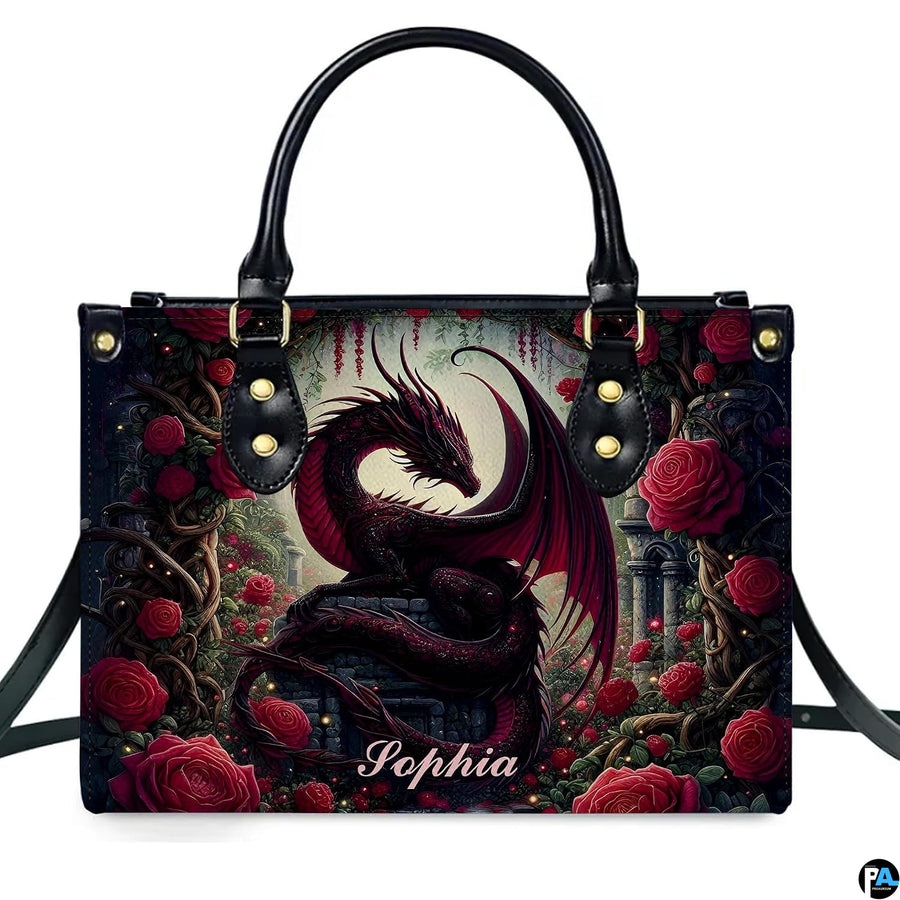 Studio front view of structured red rose dragon handbag with attached shoulder strap.