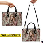 Side perspective of Madonna and Child handbag showing structured silhouette and black top handles.