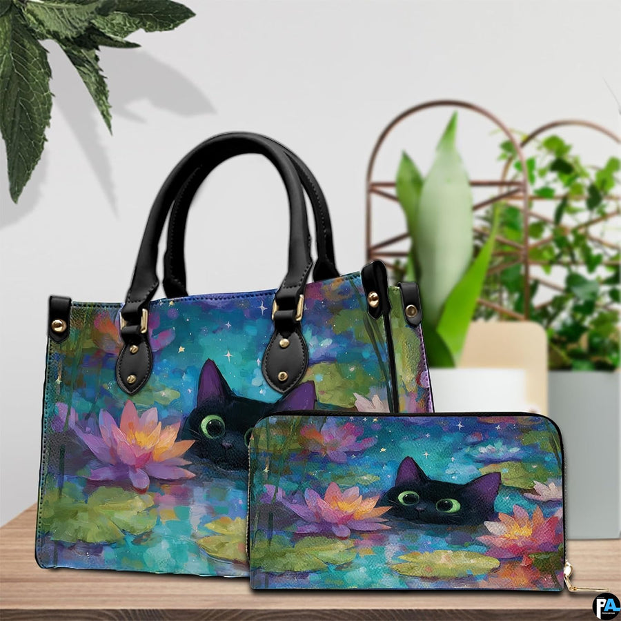 Black cat in water lily pond artwork resting beside potted greenery on a wooden table.