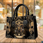 Angled perspective view of Gothic Ram Zodiac Handbag placed on a wooden deck table.