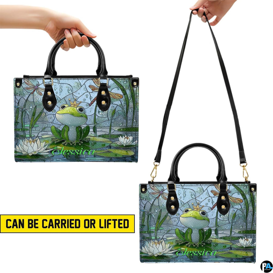Top-down view displaying interior compartment and black carrying handles of the handbag.