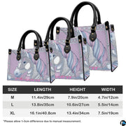 Coordinated crowned unicorn handbag and matching wallet set on white surface