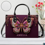 Top down view of plum butterfly handbag displaying spacious interior opening