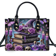 Studio frontal perspective of structured purple witch hat handbag on white background.