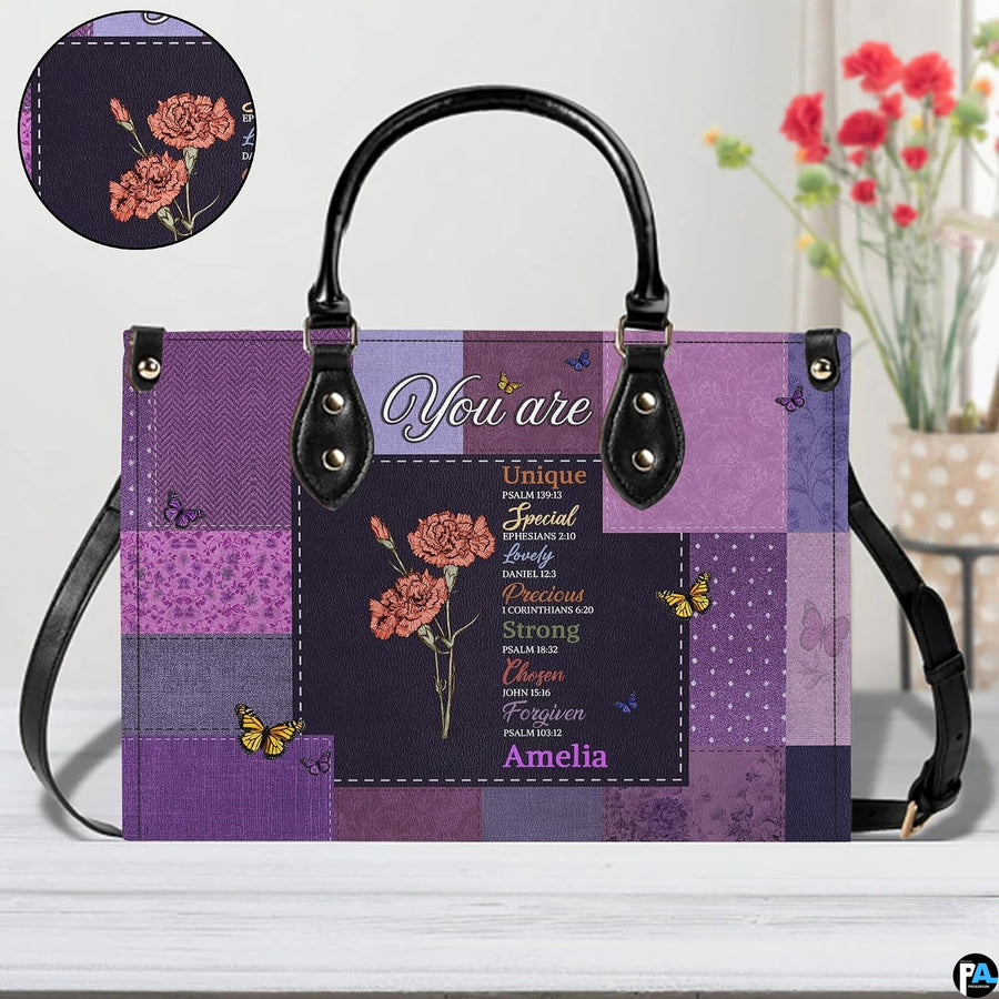 Flat view of matching purple patchwork wallet featuring carnation and butterfly botanical artwork.