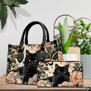 Tabletop presentation highlighting fluffy black cat art resting beside leafy indoor greenery.